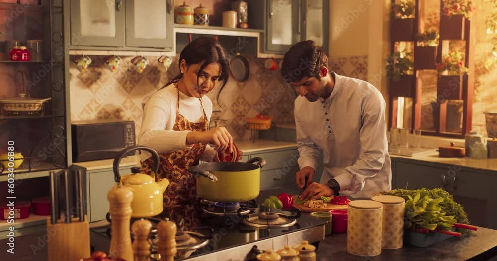 Loving Indian Couple Preparing Food Together in the Kitchen: Young Lovely Couple Enjoy Spending Time together, Learning New things, Creating Delicious Experiences. Preparing Dinner For Family, Friends Loving Indian Couple Preparing Food Together in the Kitchen: Young Lovely Couple Enjoy Spending Time together, Learning New things, Creating Delicious Experiences. Preparing Dinner For Family, Friends