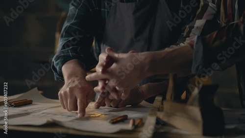 Wood, Men Concentrated Two fellow workers studying drawings of wooden parts for manufacturing In the workroom Concept Woodworker Spends working time studying new ideas Workplace, workroom
