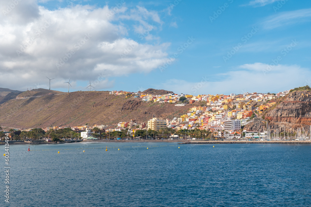 Fototapeta premium View of the city and the port of San Sebastian de la Gomera seen from the ferry heading to Tenerife. Canary Islands
