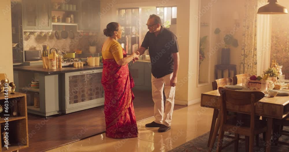 Elderly Couple Dancing in the Kitchen and Celebrating Together: Enjoying the Music and Each Other's Company with Graceful Moves and Loving Smiles. Slow Motion Wide Shot Elderly Couple Dancing in the Kitchen and Celebrating Together: Enjoying the Music and Each Other's Company with Graceful Moves and Loving Smiles. Slow Motion Wide Shot