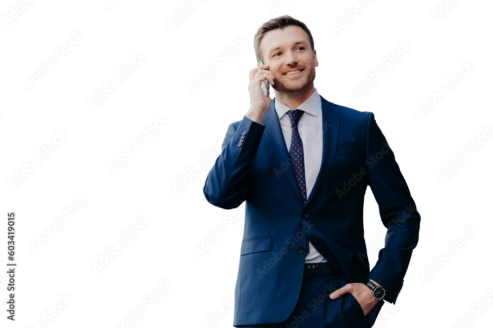 Optimistic male owner of buisness company dressed in elegant suit, has telephone conversation, consults with operator, looks into distance, has happy look, stands outside. People and communication Optimistic male owner of buisness company dressed in elegant suit, has telephone conversation, consults with operator, looks into distance, has happy look, stands outside. People and communication