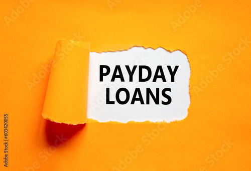 Payday loans symbol. Concept words Payday loans on beautiful white paper. Beautiful orange table orange background. Business and Payday loans concept. Copy space.