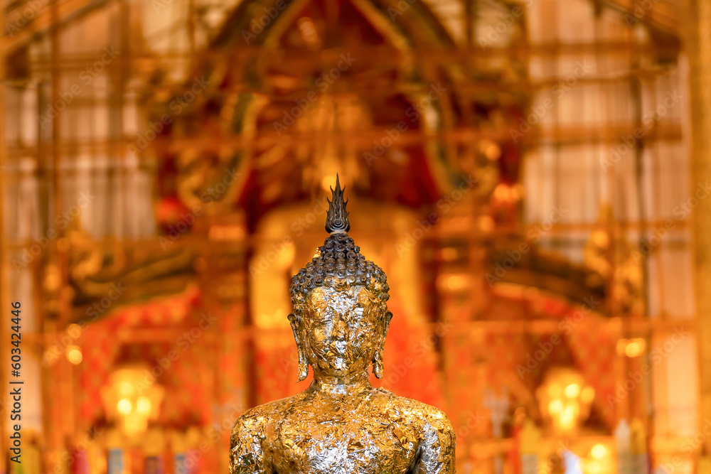 The Golden Buddha statue is under repair at Wat Chedi Luang Temple in Chiang Mai, Thailand The Golden Buddha statue is under repair at Wat Chedi Luang Temple in Chiang Mai, Thailand