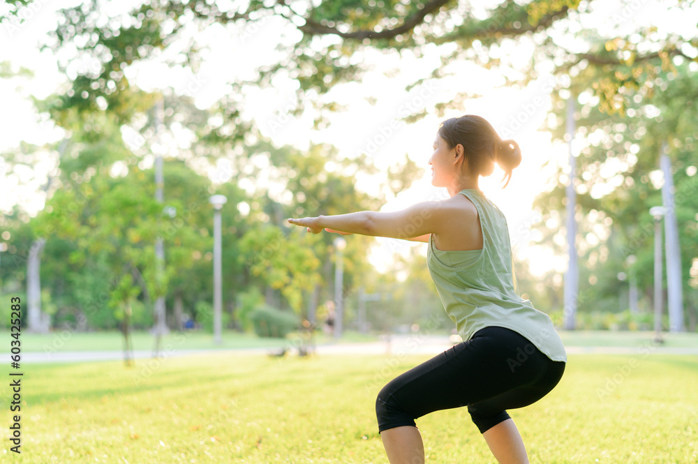 Female jogger. Fit young Asian woman with green sportswear stretching muscle in park before running and enjoying a healthy outdoor. Fitness runner girl in public park. Wellness being concept Female jogger. Fit young Asian woman with green sportswear stretching muscle in park before running and enjoying a healthy outdoor. Fitness runner girl in public park. Wellness being concept