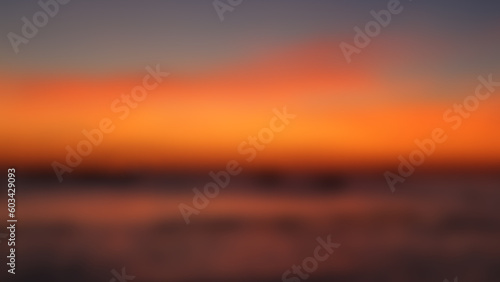 Fototapeta Naklejka Na Ścianę i Meble -  Blurred twilight sunset sky and sea natural background. Abstract dark orange night blur defocused sea background.