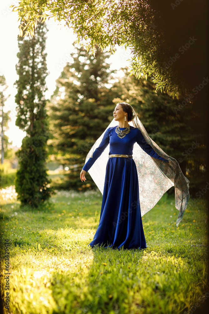 a girl in a blue dress in a spring forest a girl in a blue dress in a spring forest