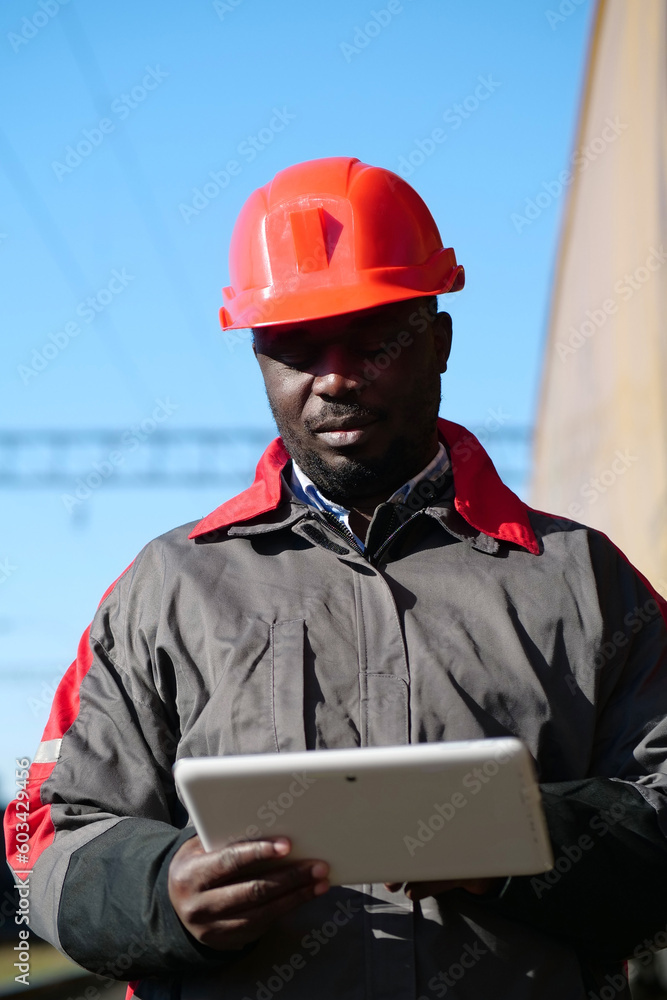 African american railway man with tablet computer at freight train terminal African american railway man with tablet computer at freight train terminal