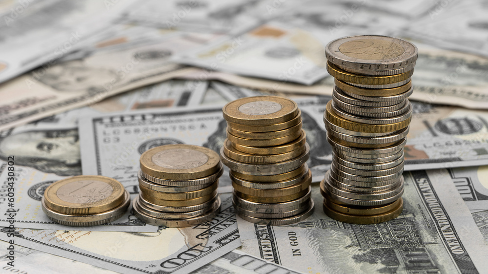 Stacks of golden coins on dollar bills on a table. Stacks of golden coins on dollar bills on a table.