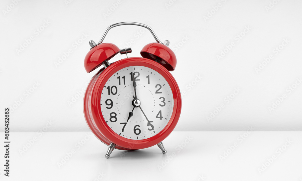Red alarm clock on white wall background Red alarm clock on white wall background