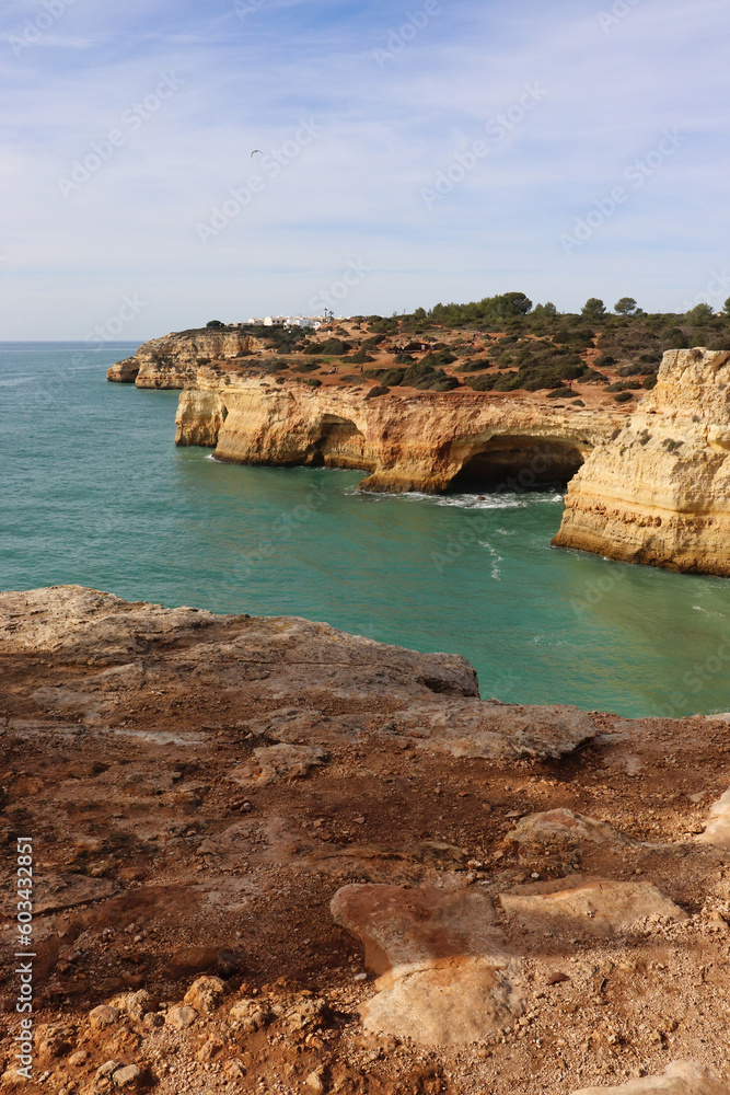 Water in the Atlantic Ocean surrounded by limestone cliffs on a sunny winter day in southern Portugal along the Seven Hanging Valleys Trail.