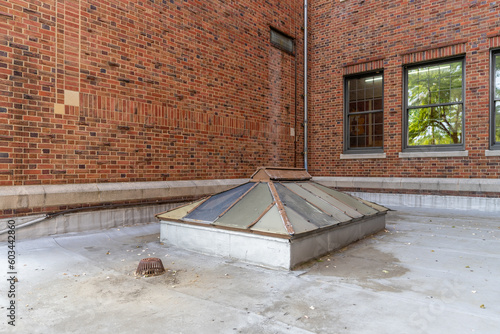 Foto Old, vintage metal framed double pitched skylight on a flat commercial, industrial, or school rooftop
