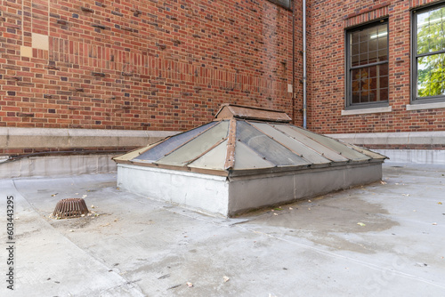 Foto Old, vintage metal framed double pitched skylight on a flat commercial, industrial, or school rooftop