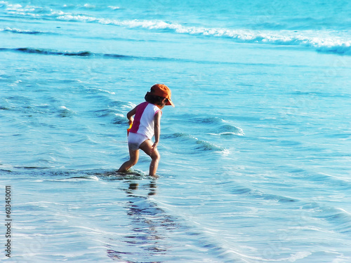 Kid playing in the ocean