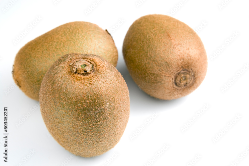 Three kiwi fruits on a white background. Horizontal shot. Three kiwi fruits on a white background. Horizontal shot.