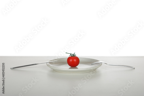 Red tomato in a plate over a table reday to be eaten photo