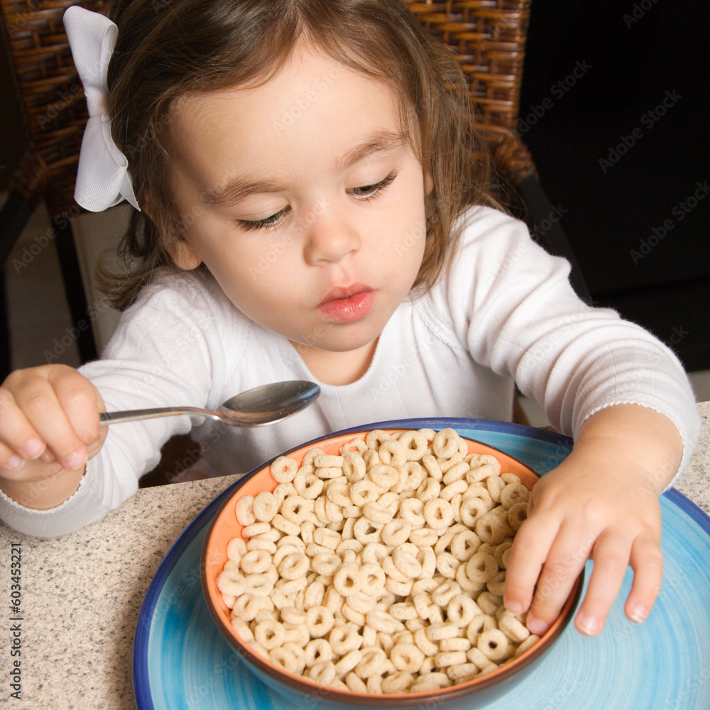 Caucasian girl eating bowl of cereal. Caucasian girl eating bowl of cereal.