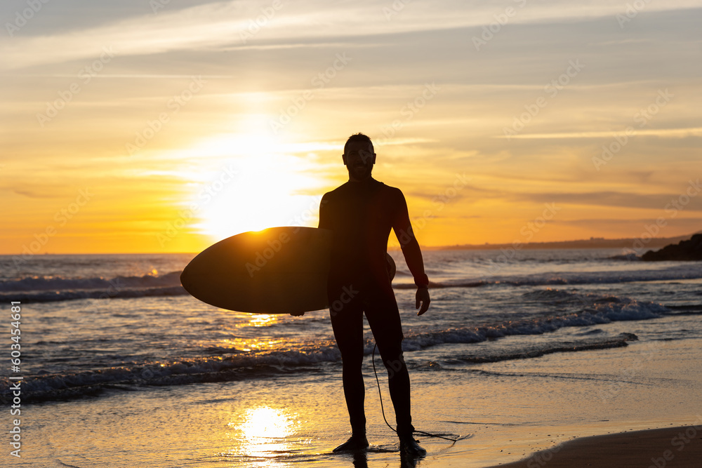 Silhouette of a man surfer on the seashore Silhouette of a man surfer on the seashore