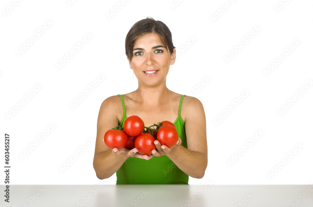 Beautiful young woman in the kitchen holding tomatos on her hands Beautiful young woman in the kitchen holding tomatos on her hands