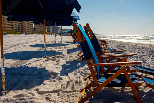 Blue Umbrellas and chairs at Ft Walton Beach Fl., Blue sky and soft sand beach. photo