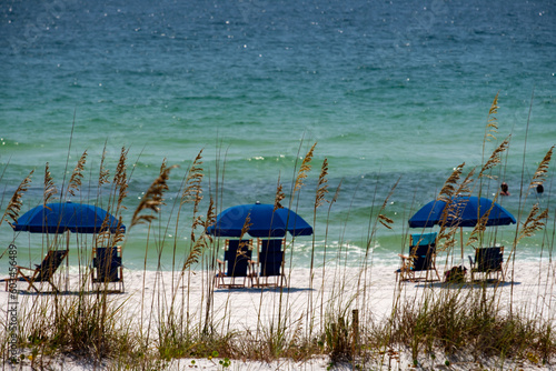 Blue Umbrellas and chairs at Ft Walton Beach Fl., Blue sky and soft sand beach.
