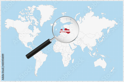 Magnifying glass showing a map of Latvia on a world map.