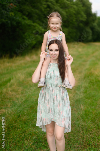 Foto Mom and girl spend time together outdoors