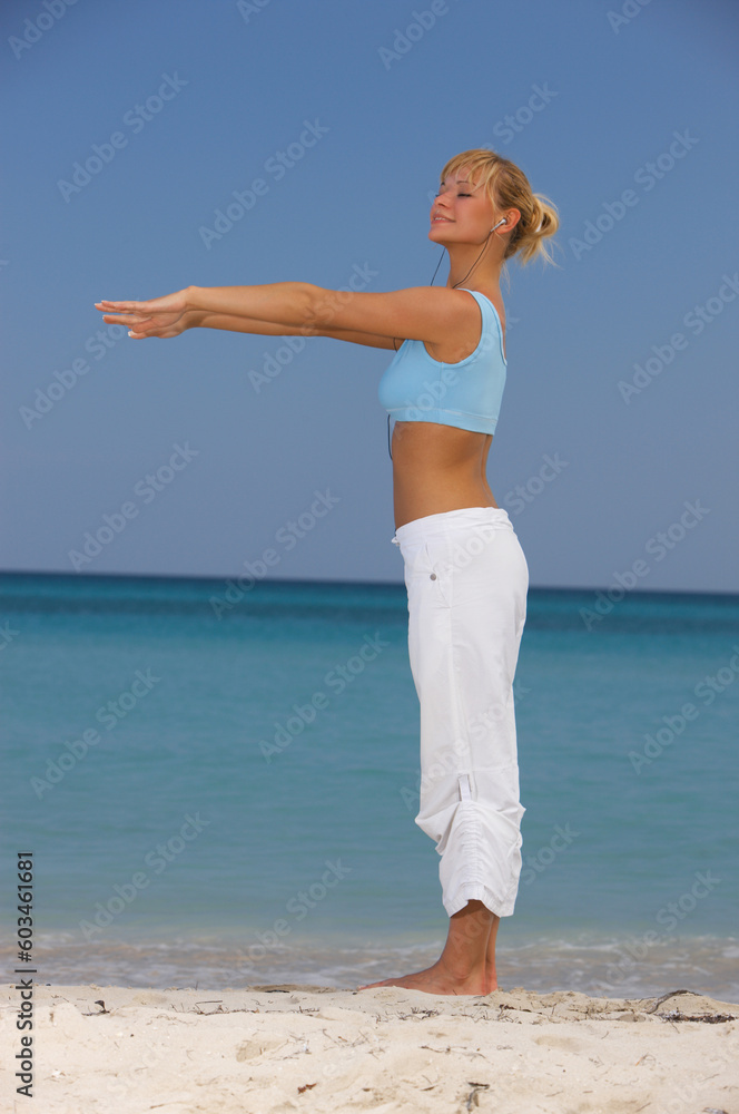 Young beautiful woman during fitness on sea beach Young beautiful woman during fitness on sea beach