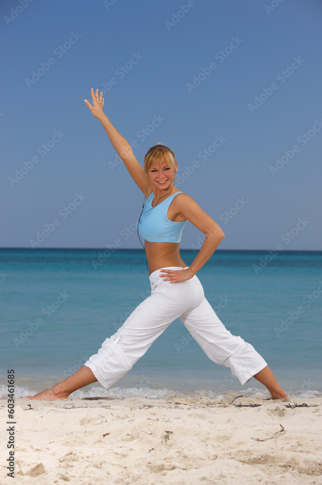 Young beautiful woman during fitness on sea beach Young beautiful woman during fitness on sea beach