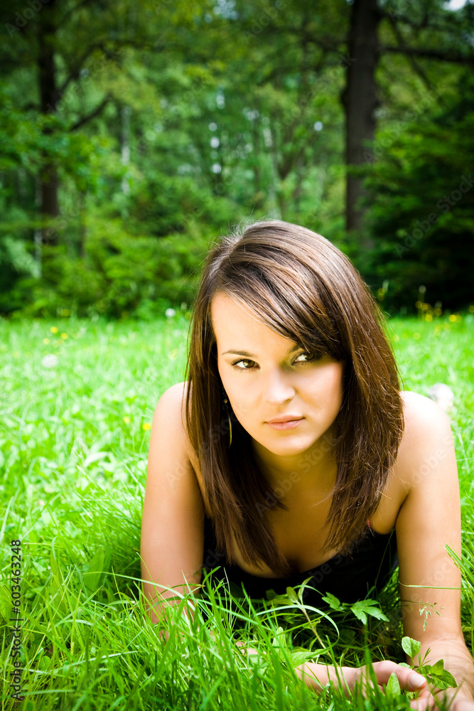 Beautiful girl lying down of grass. Copy space Beautiful girl lying down of grass. Copy space