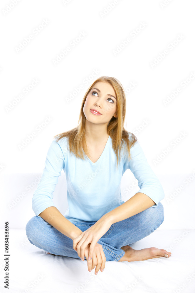 Young woman sitting on couch with crossed legs Young woman sitting on couch with crossed legs