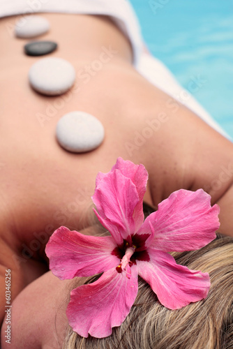 Woman at a spa with white stone on her forehead