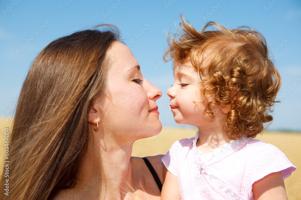 Portrait of mother and daughter looking at each other Portrait of mother and daughter looking at each other