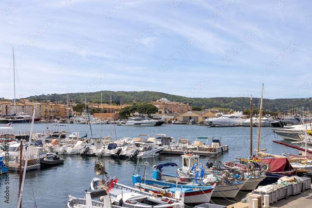 Marina with yachts and shipping boats and promenade in Saint Tropez, Cote d'Azur, French Riviera