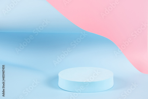 Abstract trendy composition with empty round podium platform for product or cosmetics presentation on pastel pink and light blue background. Trendy modern curved shaped lines. Front view