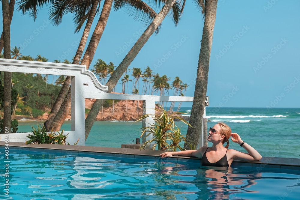Fototapeta premium Travel. Retrit travel.Travelers woman coast ocean tropical island.wellness Solitude,wildlife,mental health,conscious travel,travel active life .Travel sea banner,retreat, perspective,deserted beach