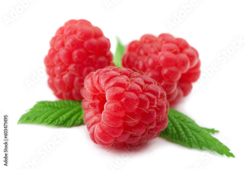 Raspberries with green leaves on white background