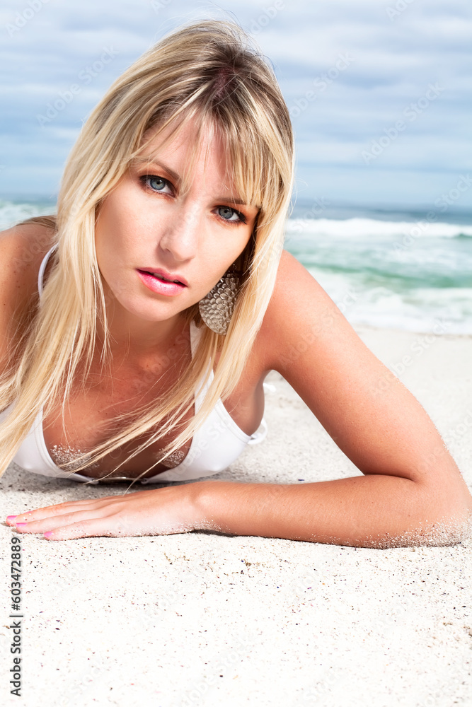 Hot blond in a white bikini having a good time on the beach.