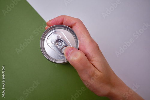 Empty soda can, focus on drink on light background. Place for text and information 