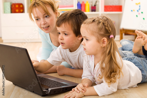 Family online - kids learning the use of computers with their mother