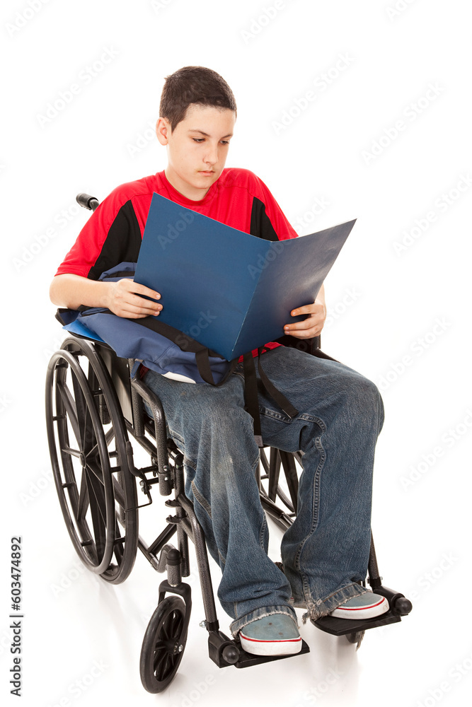 Disabled teen school boy reading in his wheelchair. Full body isolated. Disabled teen school boy reading in his wheelchair. Full body isolated.