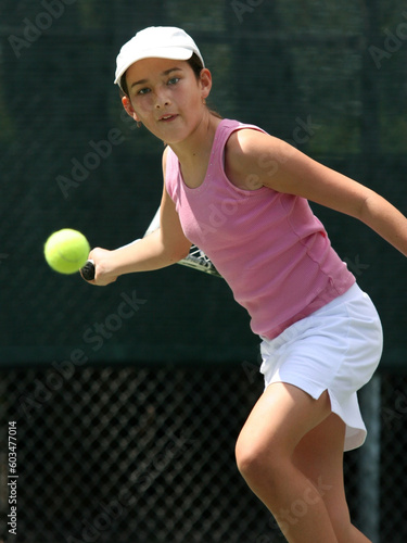 Teenage girl playing tennis © Designpics