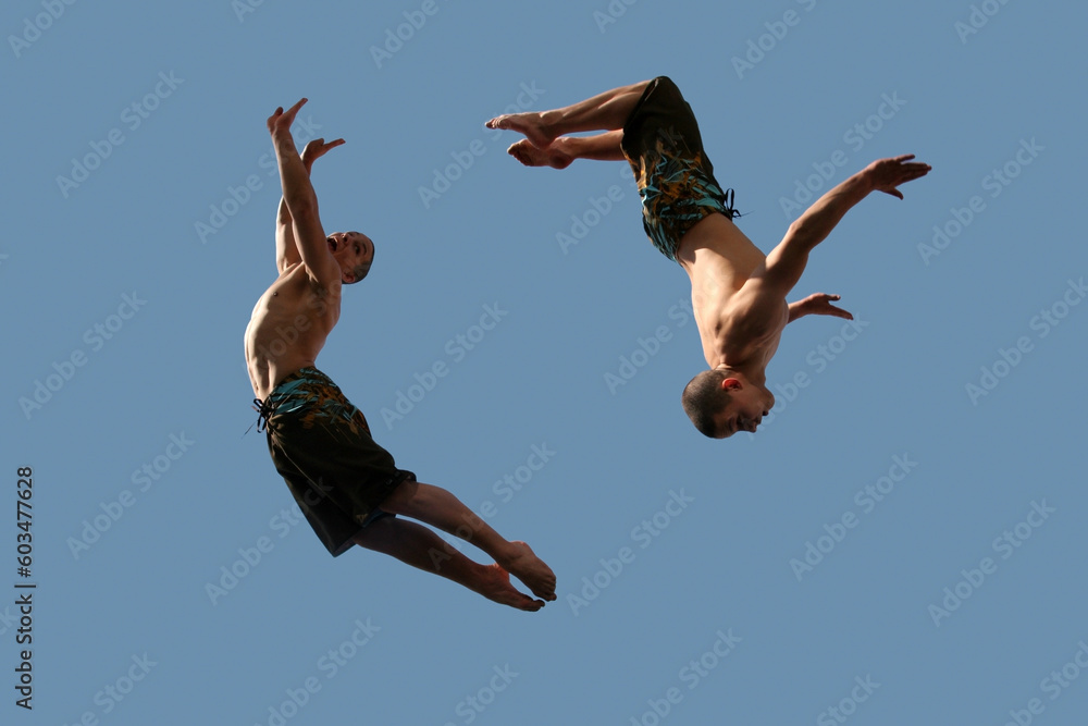 An image of two flying young athletic men