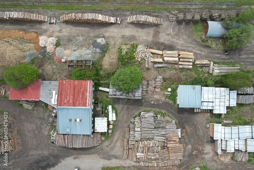 Aerial view of stacked logs near a railway yard, showcasing industrial timber storage and its role in the logistics of wood transportation photo