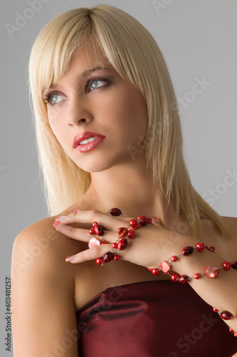 cute blond girl with glamor make up with red necklace