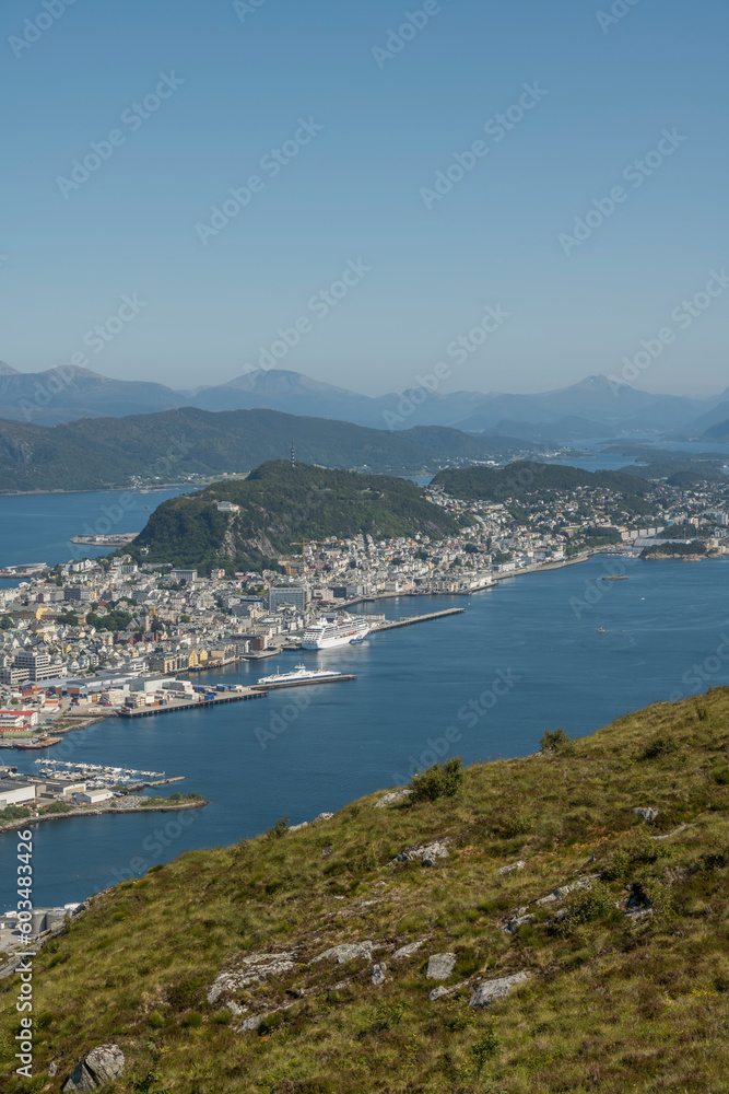 Summer view from Sukkertoppen mountain toward the surrounding islands and ocean. Bushes in the foreground. View on Ålesund. hiking, trekking, summer