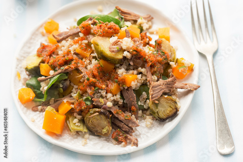 Pearl barley and beef salad with pickled pumpkin and brussel sprouts and red pepper dressing