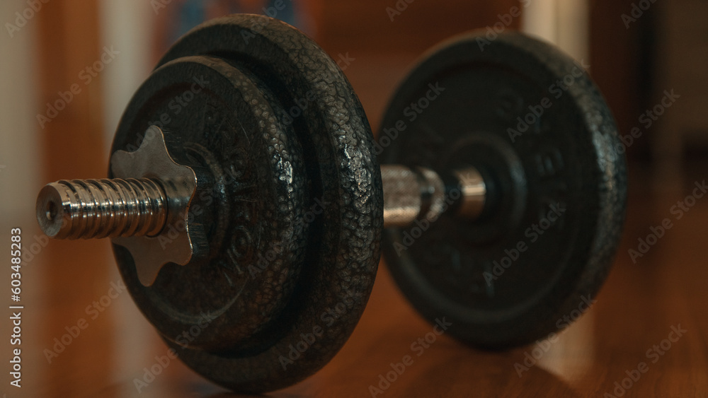 Dumbbells on a wooden floor. Close-up. Dumbbells on a wooden floor. Close-up.