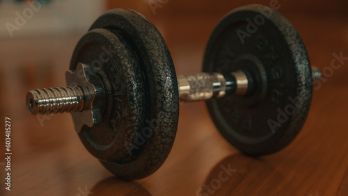 Dumbbells on a wooden floor. Close-up. photo