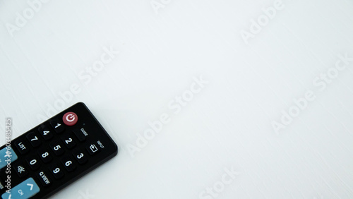 TV remote control on white background. Selective focus and shallow depth of field.