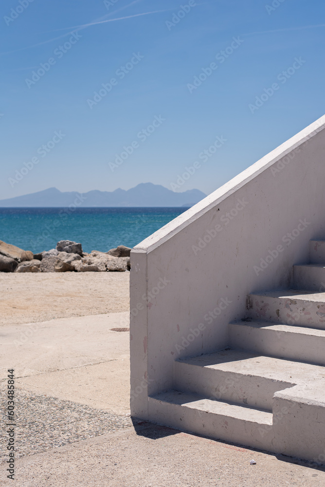 Fototapeta premium white stairway stairs by the sea mountains on the horizon wallpaper minimalistic greece greek view landscape kardamena kos blue